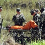 Transporting a Guantanamo captive on a stretcher in 2002 (picture US Department of Defense)